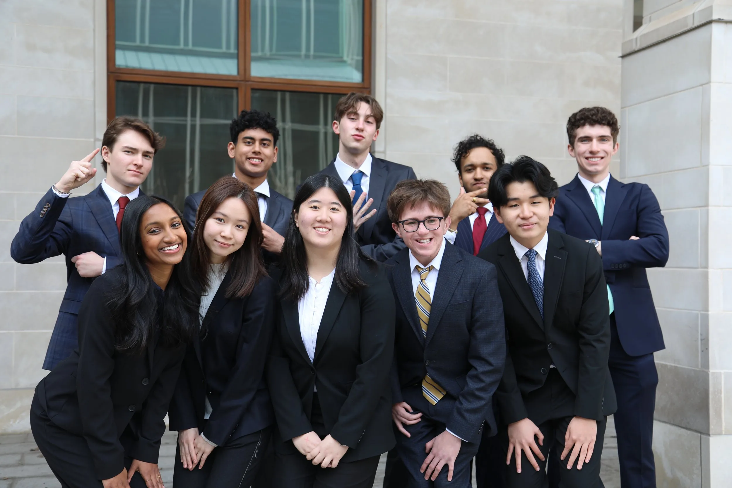 180 Degrees Consulting WashU members together outside a campus building